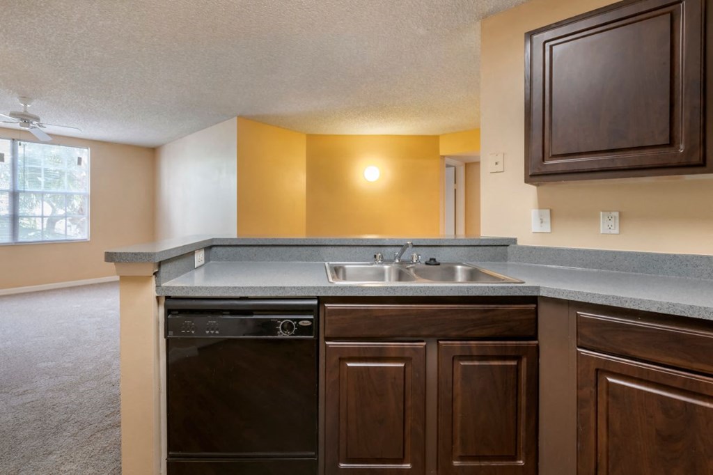 Kitchen breakfast bar, double basin sink, and dark espresso cabinetry