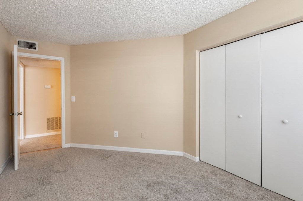 Bedroom with carpet flooring and large reach-in closet