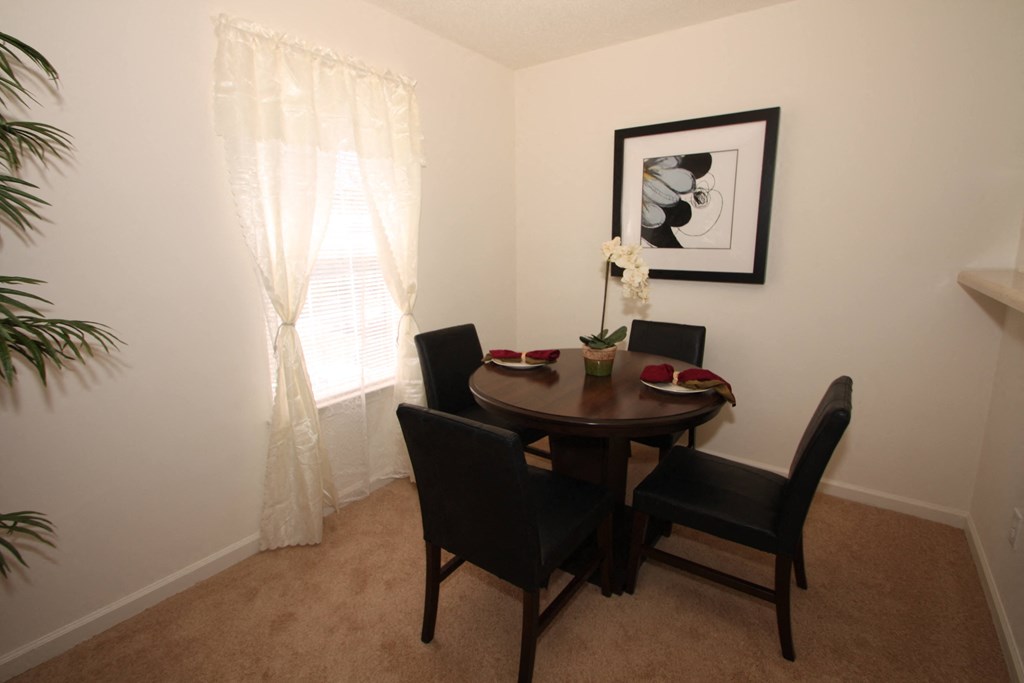 Model Dining Room  with Dining Table Next to Window and Decorations