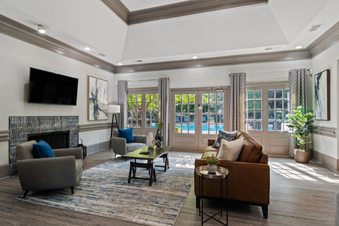 Durant at Sugarloaf Apartments clubhouse featuring seating, tv and a view of the community pool
