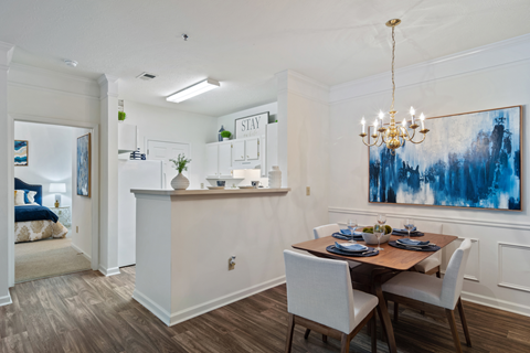 a dining area with a table and chairs and a chandelier