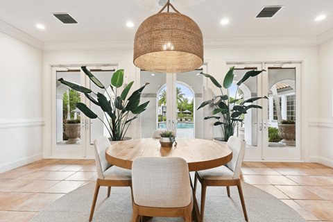 a dining room with a large pendant light and a round dining table