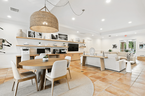 A modern kitchen with a dining table and chairs.