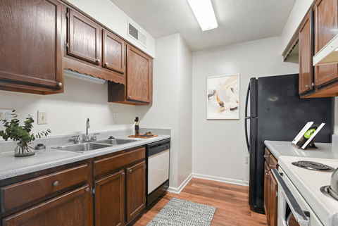 a kitchen with dark wood cabinets and white appliances