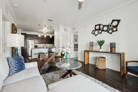 A living room with a white couch and a coffee table.