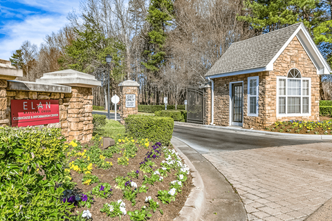 a stone building with a sign that says elan apartments at Elan at Mallard Creek Apartment Homes, Charlotte