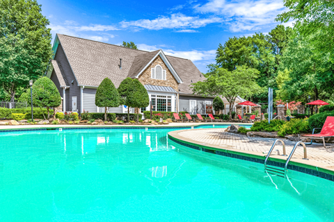 a swimming pool with a house in the background at Elan at Mallard Creek Apartment Homes, Charlotte, 28269