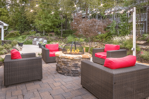 a patio with a fire pit and wicker furniture at Elan at Mallard Creek Apartment Homes, Charlotte, North Carolina
