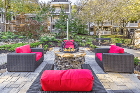 a seating area with a fire pit in the middle of a brick patio at Elan at Mallard Creek Apartment Homes, North Carolina, 28269