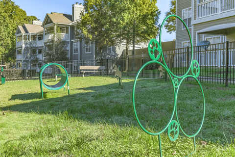 a park with a seesaw in the foreground and houses in the background at Elan at Mallard Creek Apartment Homes, Charlotte, NC, 28269