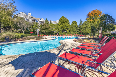 a pool with lounge chairs and trees in the background at Elan at Mallard Creek Apartment Homes, Charlotte, NC