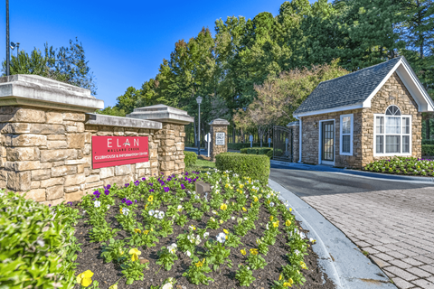 a stone building with a red sign that says elan at Elan at Mallard Creek Apartment Homes, North Carolina
