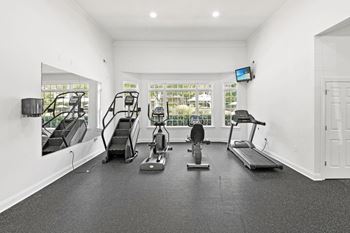 A spacious home gym with a variety of exercise equipment at Elan at Mallard Creek Apartment Homes, Charlotte, 28269
