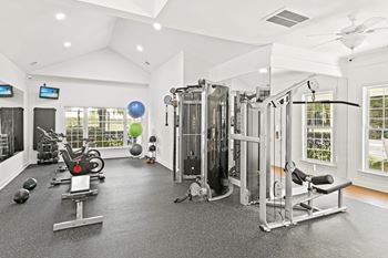 A spacious home gym with a variety of exercise equipment at Elan at Mallard Creek Apartment Homes, Charlotte, NC