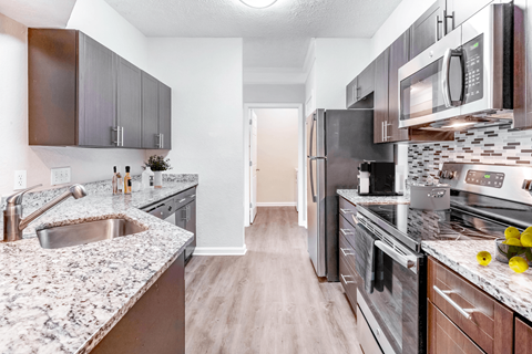 a kitchen with granite countertops and stainless steel appliances at Elan at Mallard Creek Apartment Homes, Charlotte, NC