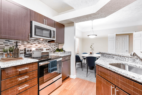a kitchen and dining area in a 555 waverly unit