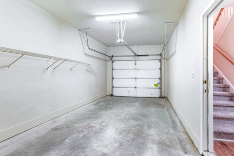 a white garage with a white wall and a white ceiling with a fluorescent light at Elan at Mallard Creek Apartment Homes, Charlotte