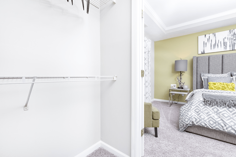 a bedroom with a bed and a closet at Elan at Mallard Creek Apartment Homes, Charlotte, North Carolina