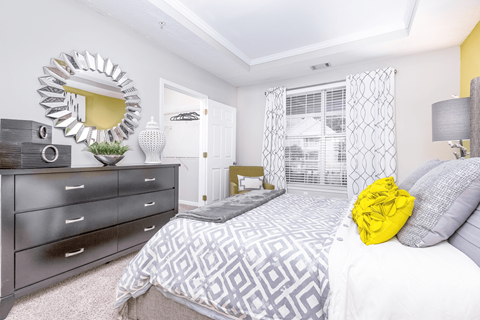 a bedroom with a bed and dresser at Elan at Mallard Creek Apartment Homes, Charlotte, NC, 28269