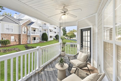 A white porch with a ceiling fan and a chair at Elan at Mallard Creek Apartment Homes, Charlotte, North Carolina