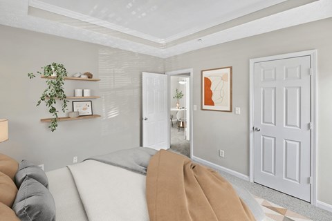 A living room with a grey couch and a white door at Elan at Mallard Creek Apartment Homes, North Carolina