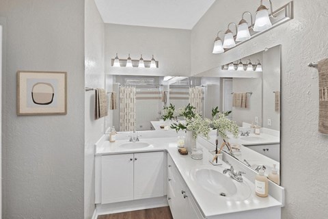 A bathroom with two sinks and a large mirror at Elan at Mallard Creek Apartment Homes, Charlotte, NC, 28269