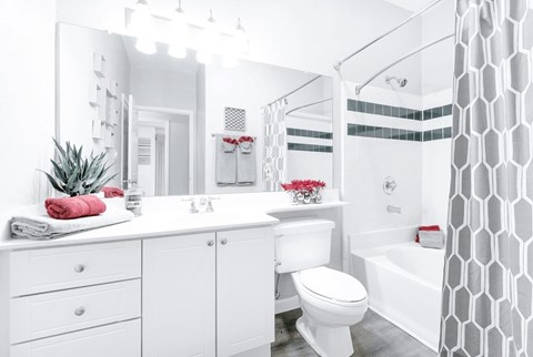 A white bathroom with a toilet, sink, and bathtub at Elan at Mallard Creek Apartment Homes, Charlotte