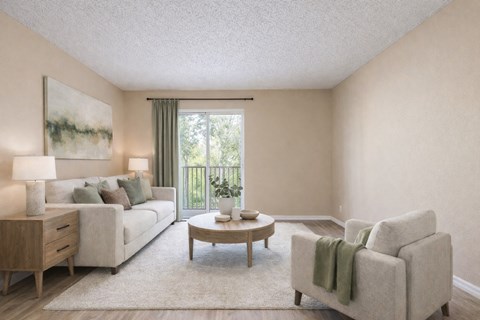 A living room with a couch, a chair, a coffee table, and a painting on the wall.