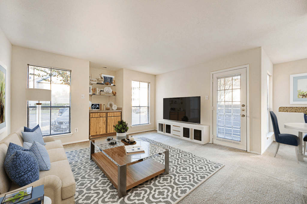 a living room with a couch and a coffee table and a television