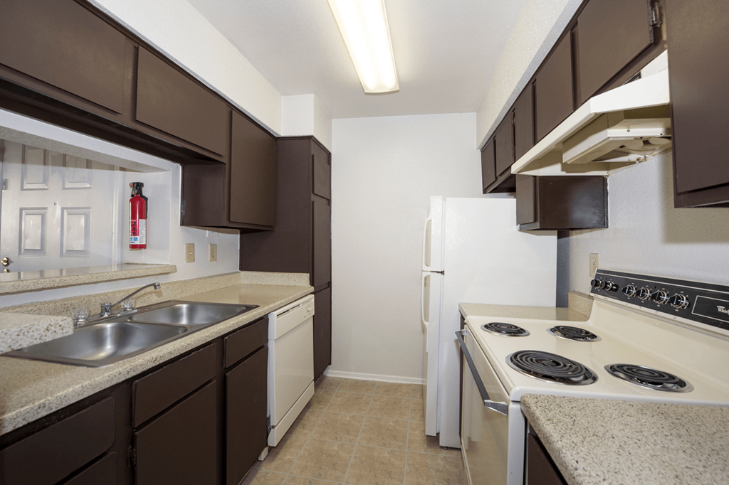 a kitchen with white appliances and brown and white cabinets