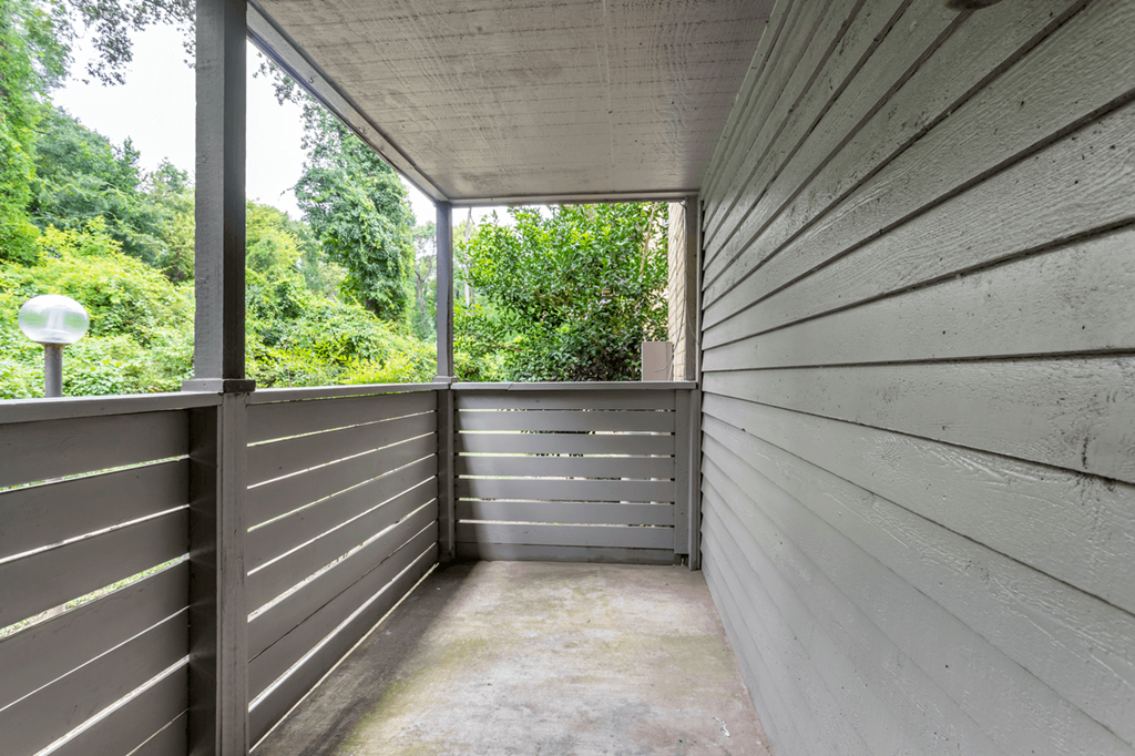 the enclosed porch has a view of the trees