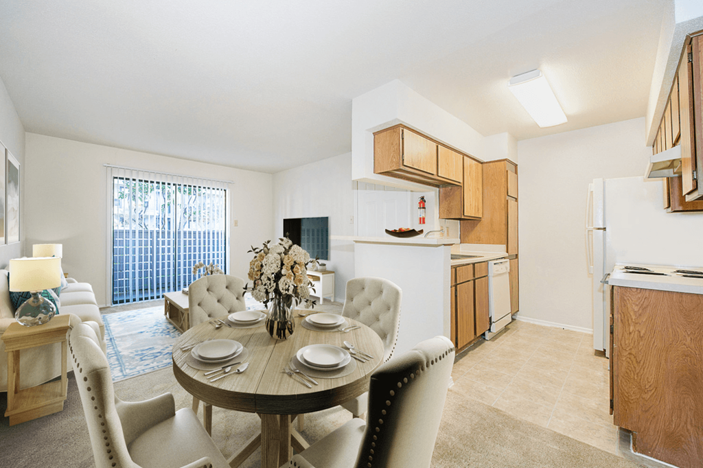 a dining room and kitchen with a table and chairs