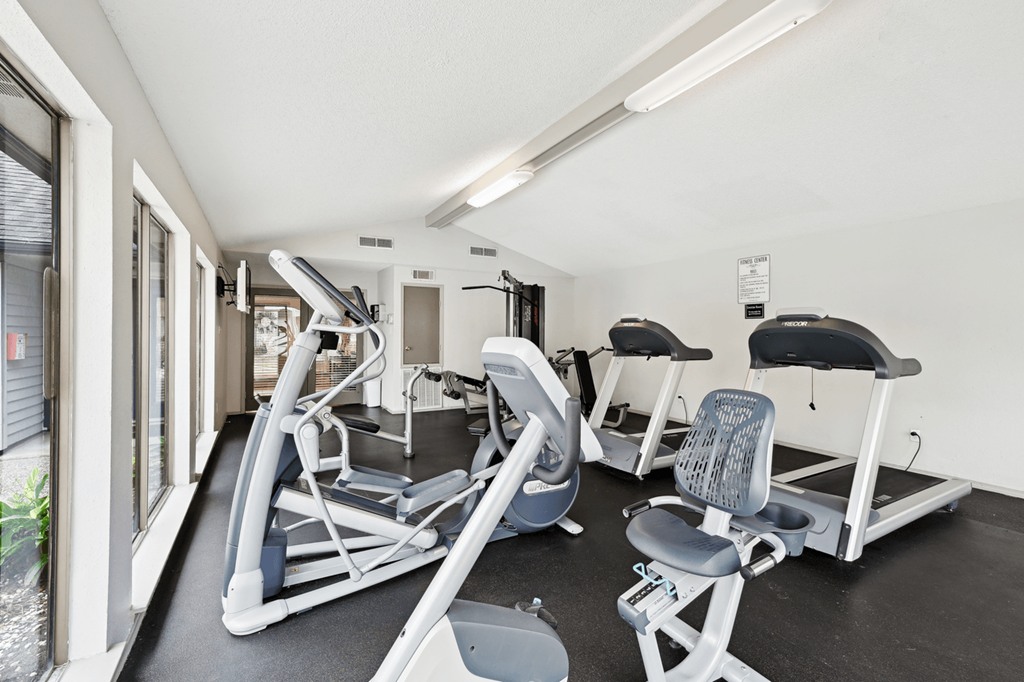the gym has plenty of cardio equipment at the enclave at university heights apartments