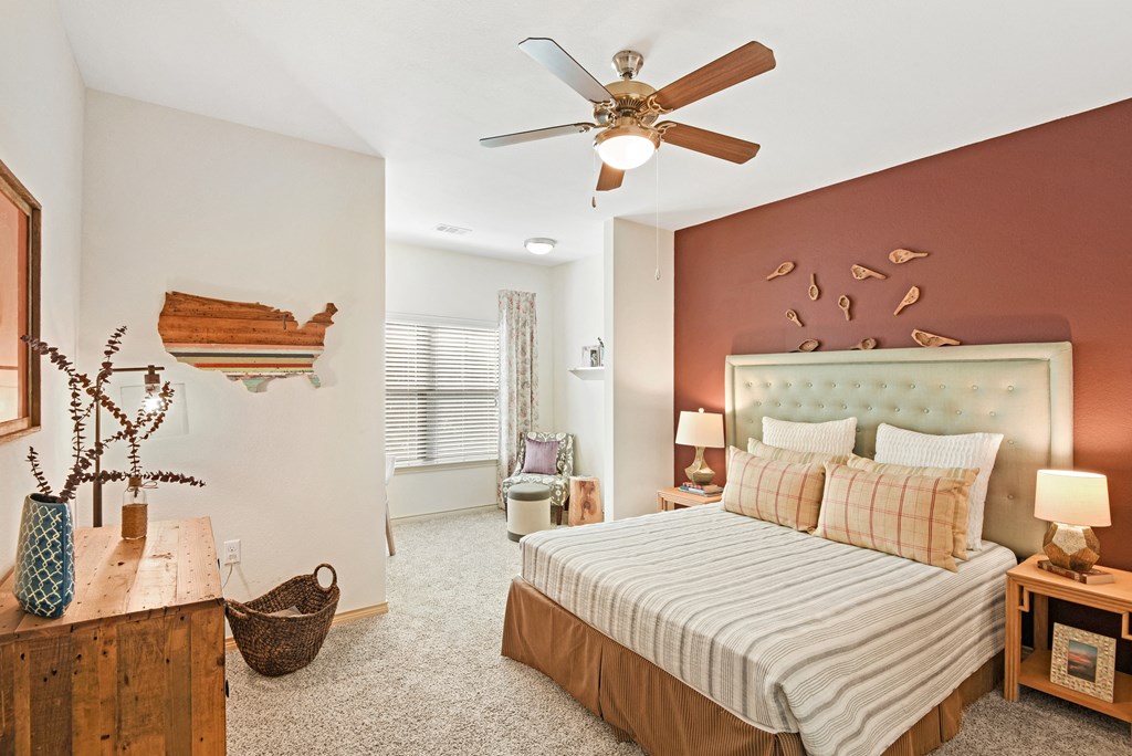 a bedroom with a bed and a ceiling fan