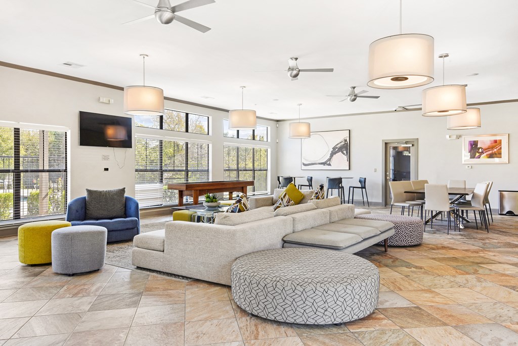 a living room filled with furniture and a large window