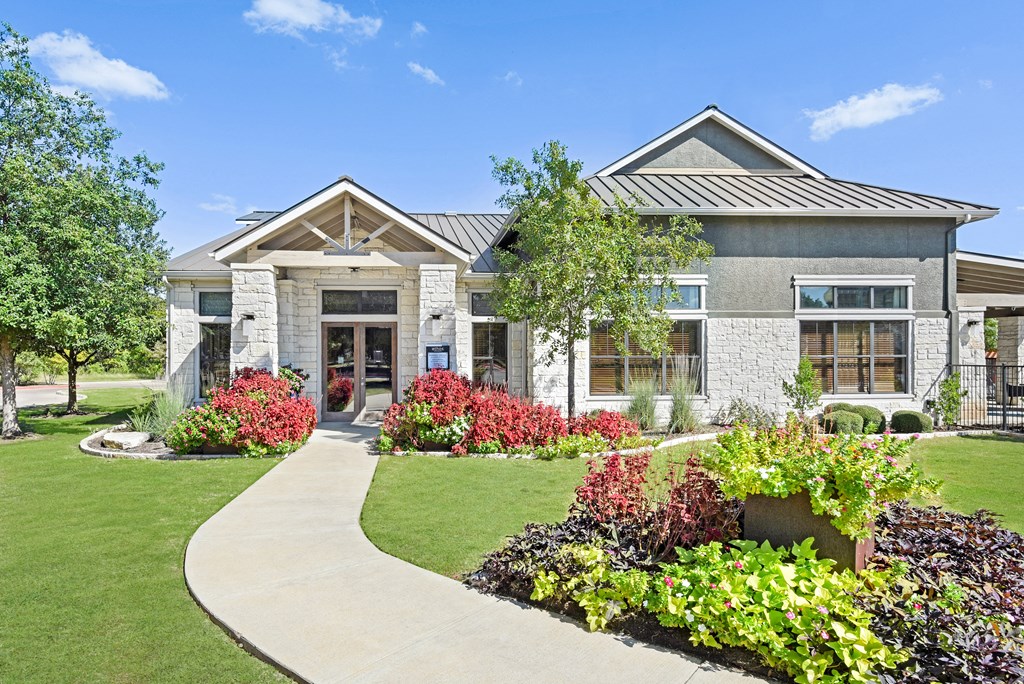 a home with a walkway leading to the front door