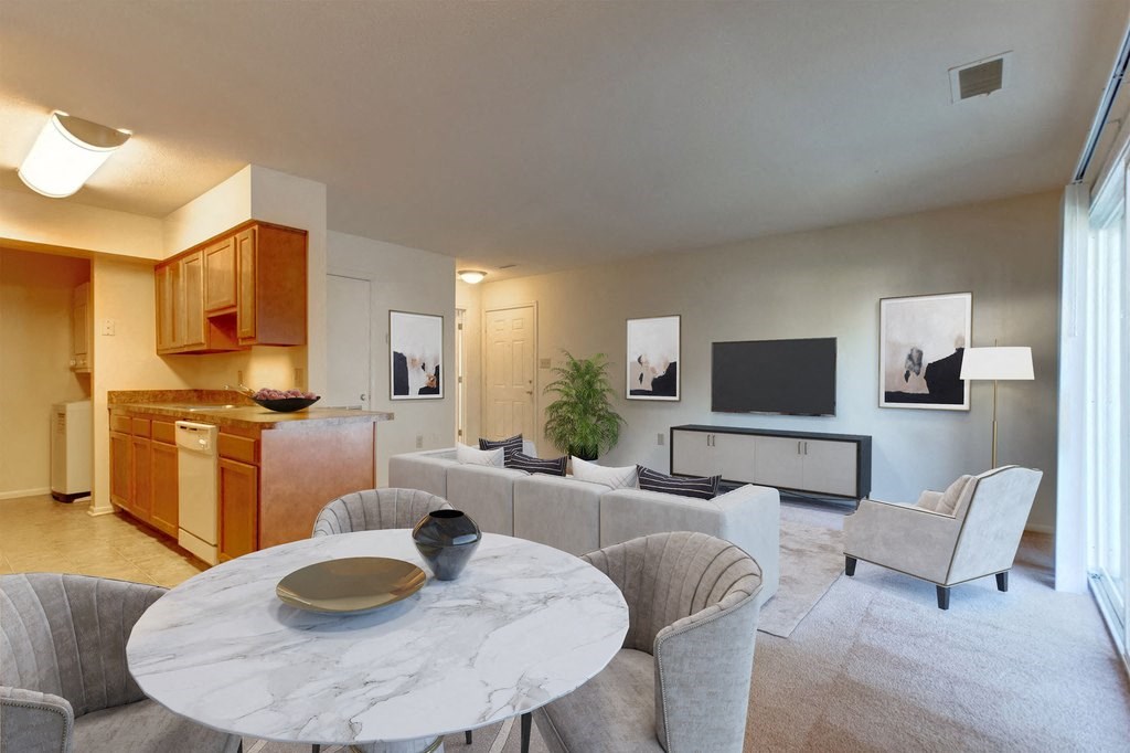 a kitchen and living room with a white marble table and chairs