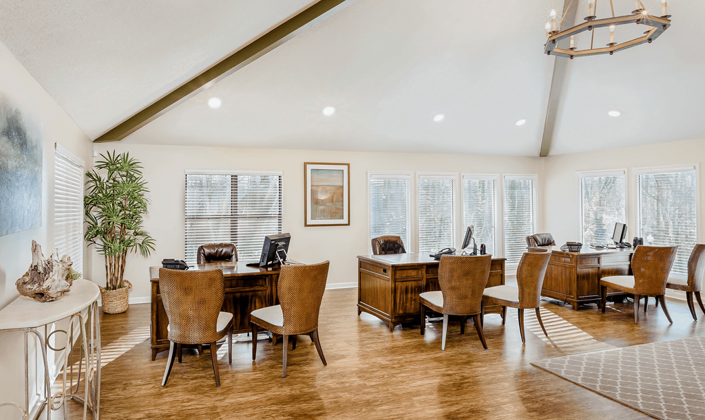 a dining room with a table and chairs and a large window
