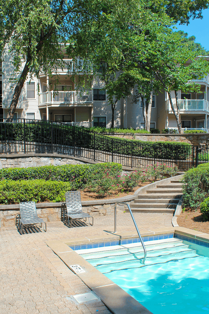 a swimming pool in front of an apartment building