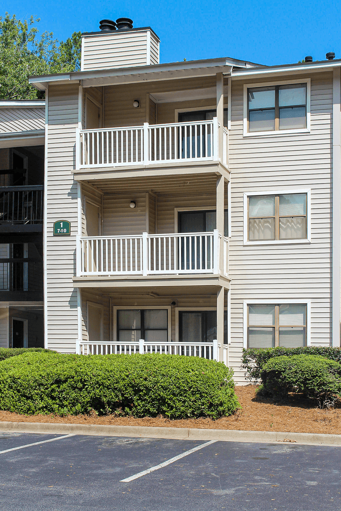 a condo building with balconies and a street sign