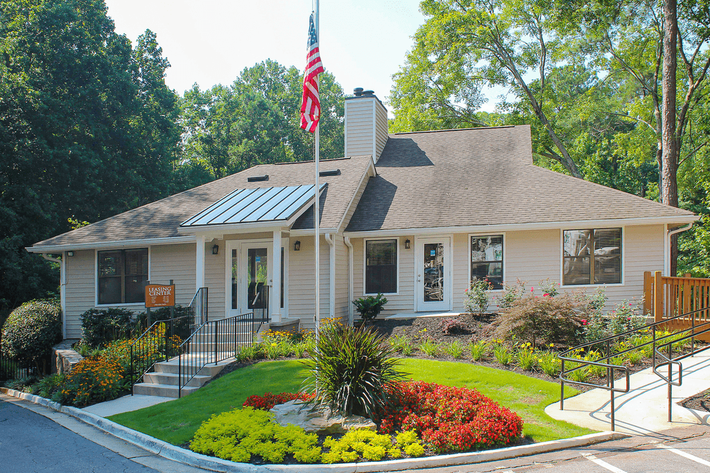 a white house with an flag in front of it