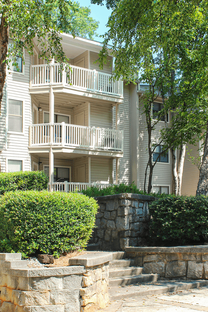 a view of the exterior of an apartment building with stairs