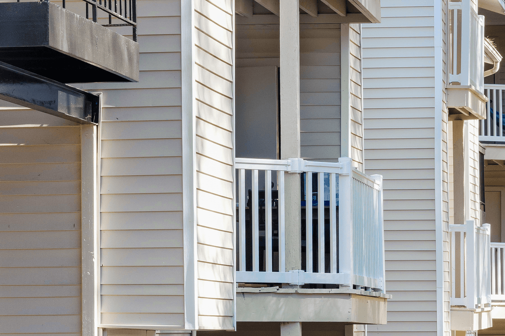 a window on the side of a house with a balcony