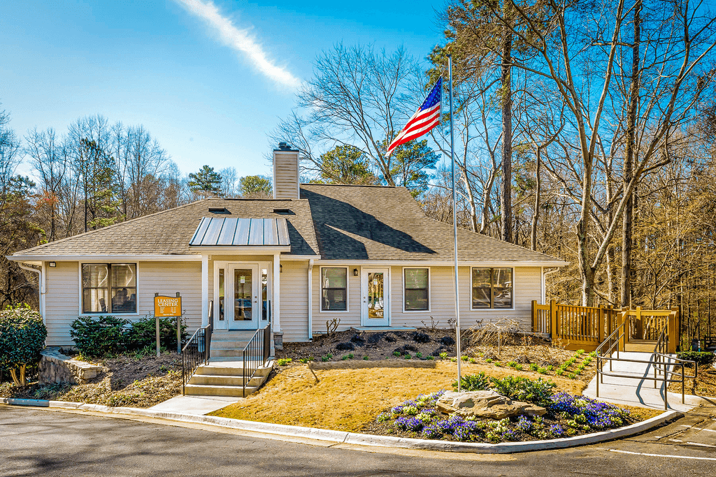 a small white house with an flag in front of it