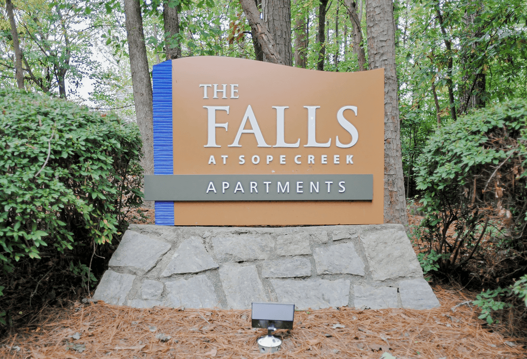 a sign for the falls at sope creek apartments