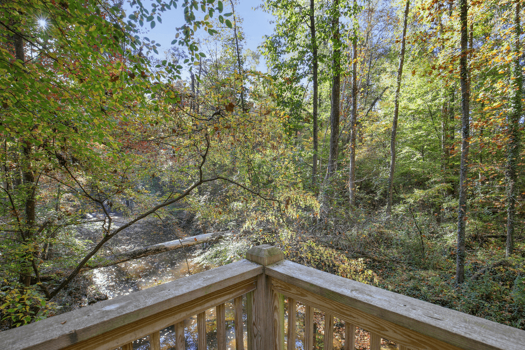 the view from the deck of a cabin in the woods