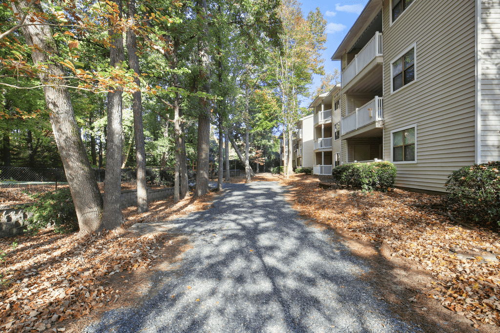 the pathway leading to the apartment buildings and trees
