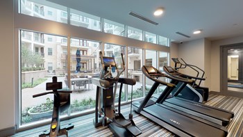 Fitness center facing treadmills and stair climber next to exterior window - Photo Gallery 97