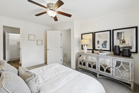 a bedroom with a large bed and a ceiling fan