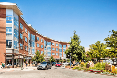 A large building with a parking lot in front of it.